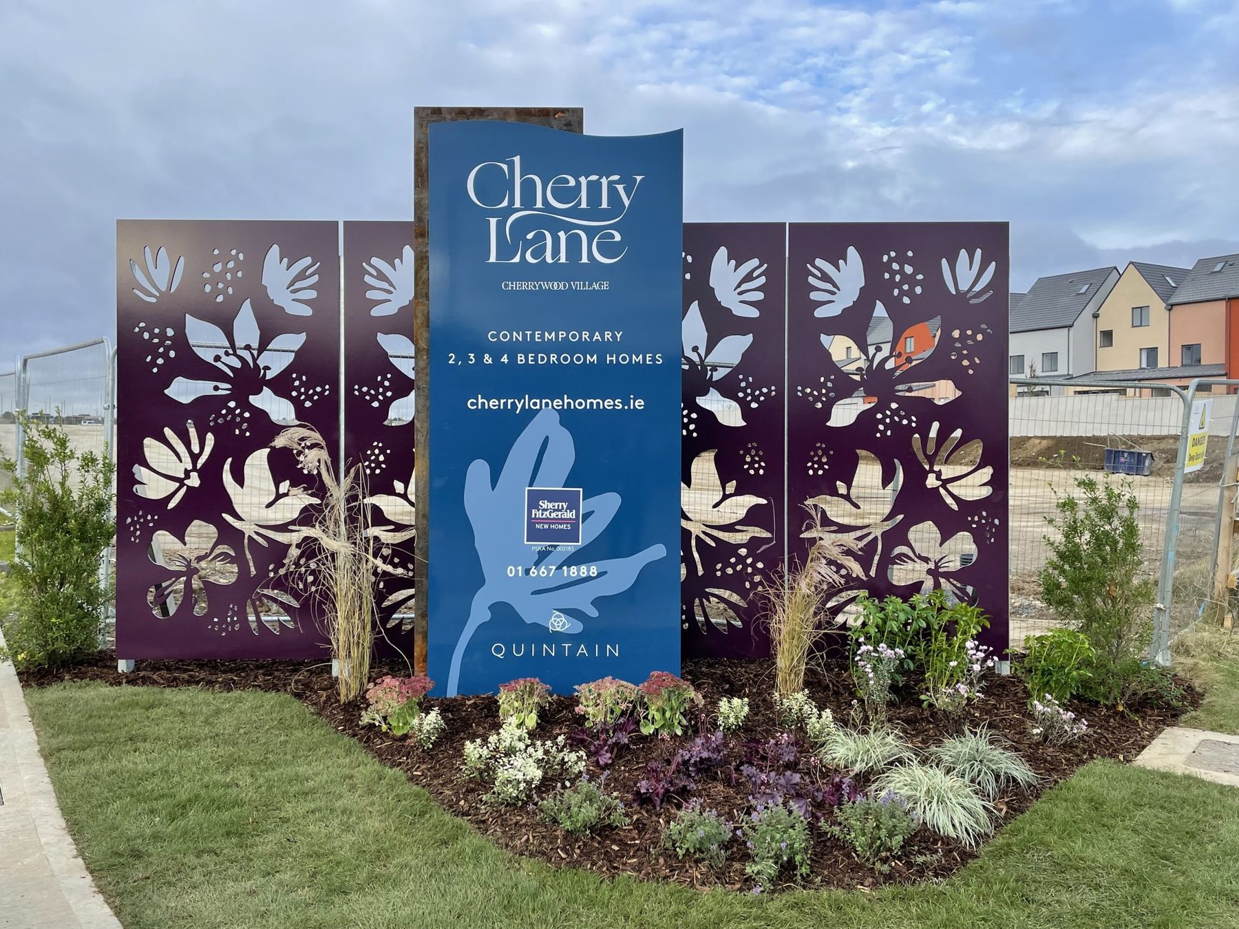 Cherry Lane marketing entrance with a blue sign, purple laser-cut floral panels and planting