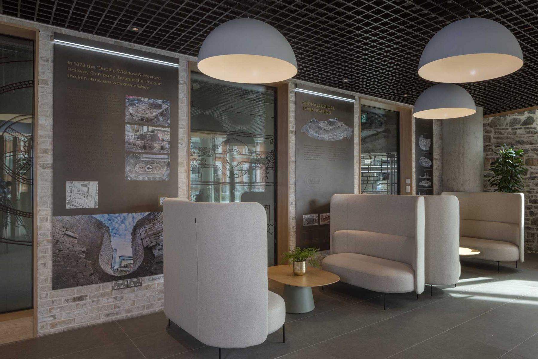 Lounge with high-backed booths, pendant lights and display walls